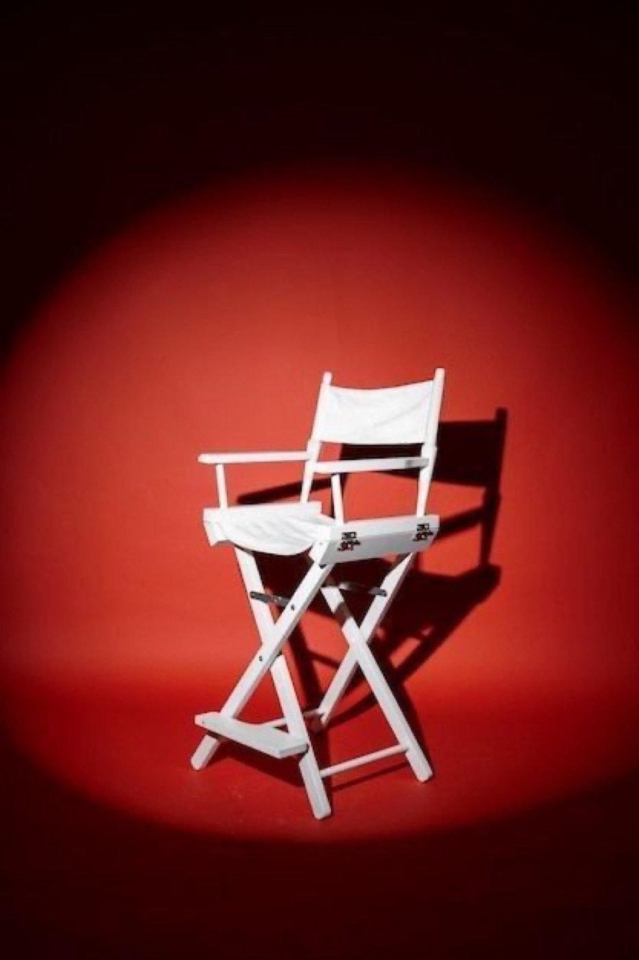 Director's chair under a red spotlight
